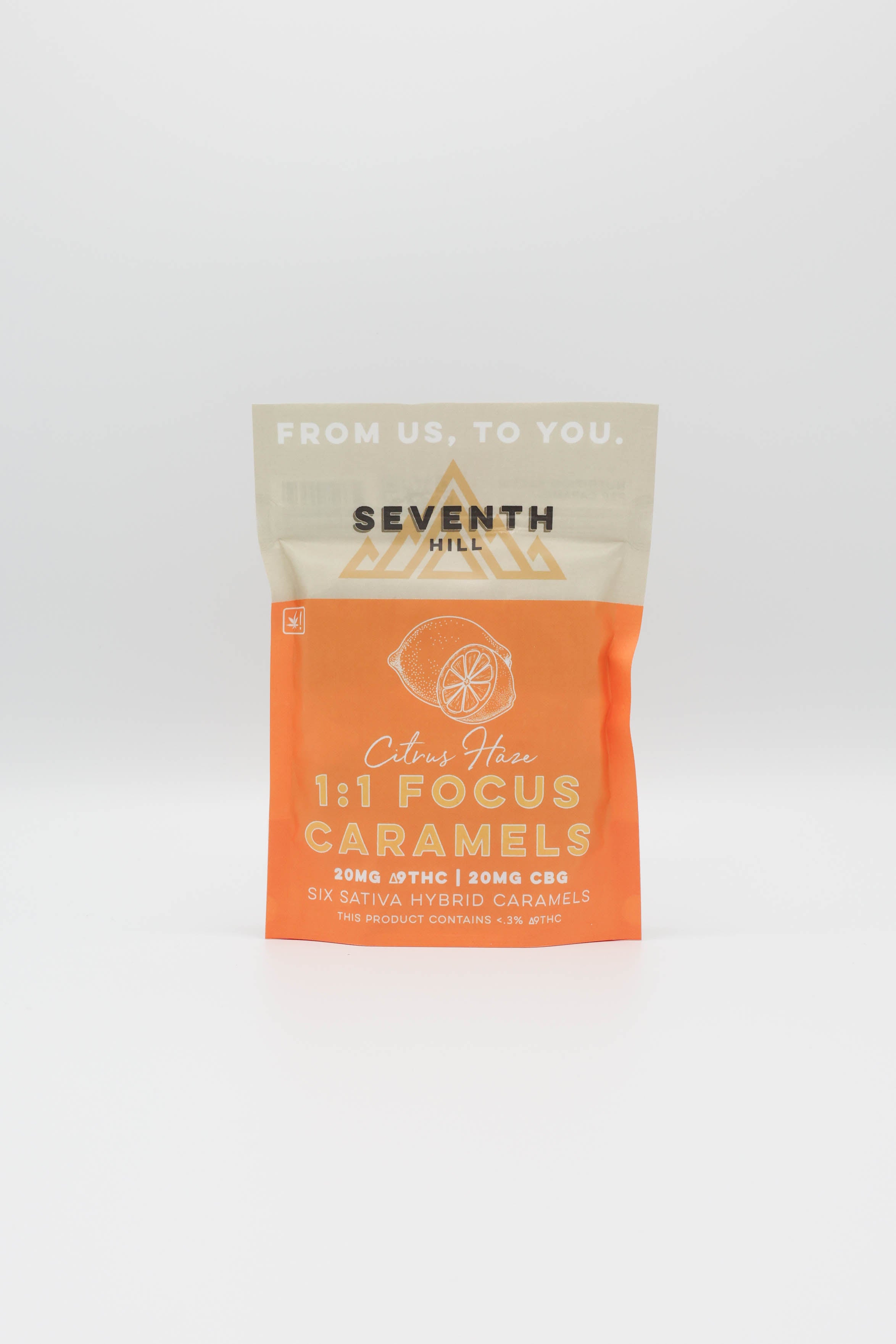 A stand-up pouch of Seventh Hill Citrus Haze 1:1 CBG Focus Caramels, featuring a bright orange lower half and a light beige upper half with the brand logo and product name.