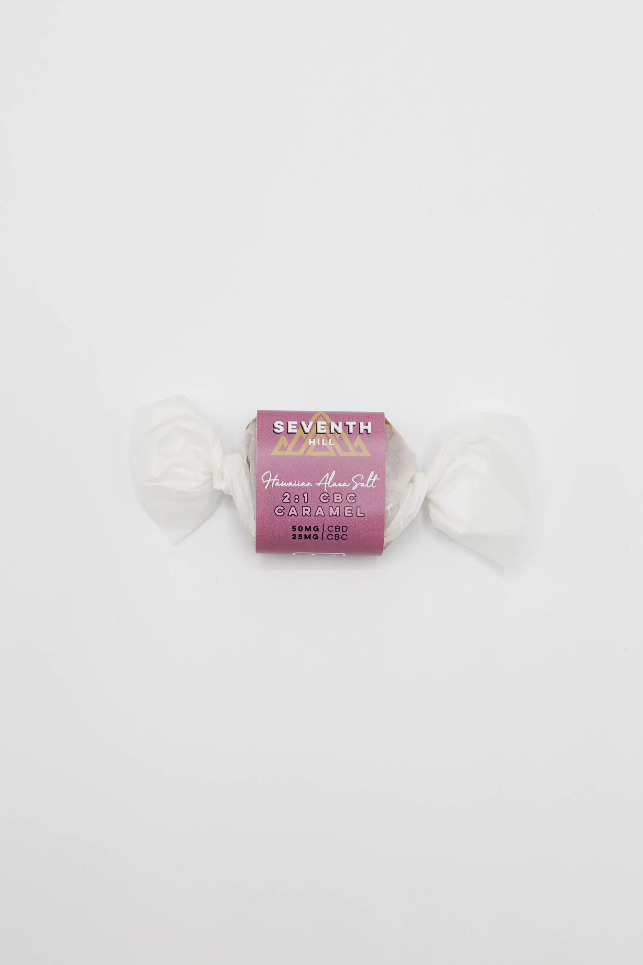 A single wrapped candy from Seventh Hill, specifically 'Hawaiian Alaea Salt' 2:1 CBC Caramel, centered on a plain white background.