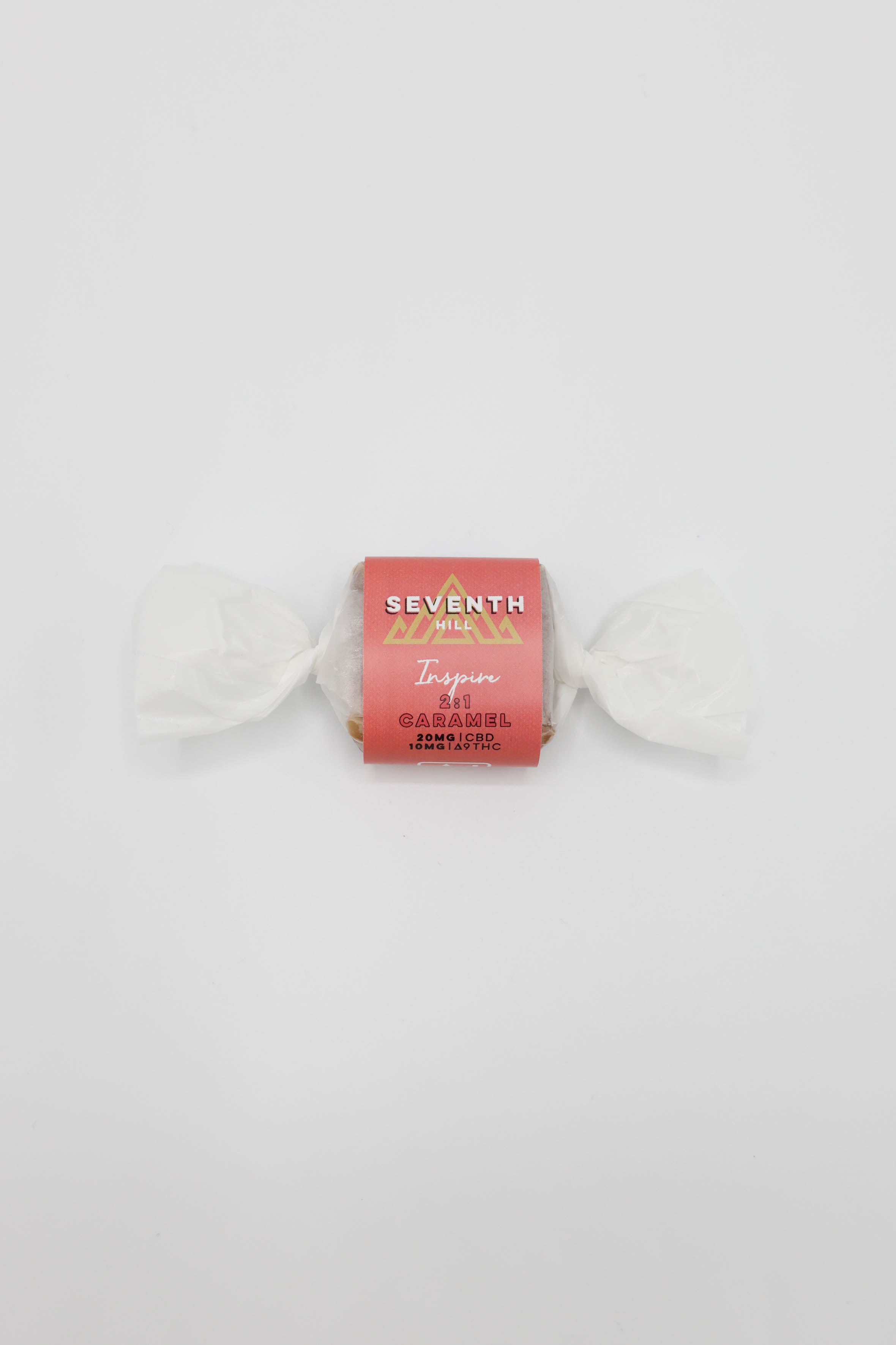 A wrapped piece of caramel from Seventh Hill with the words, "2:1 Inspire Caramel" on it, set against a white background.