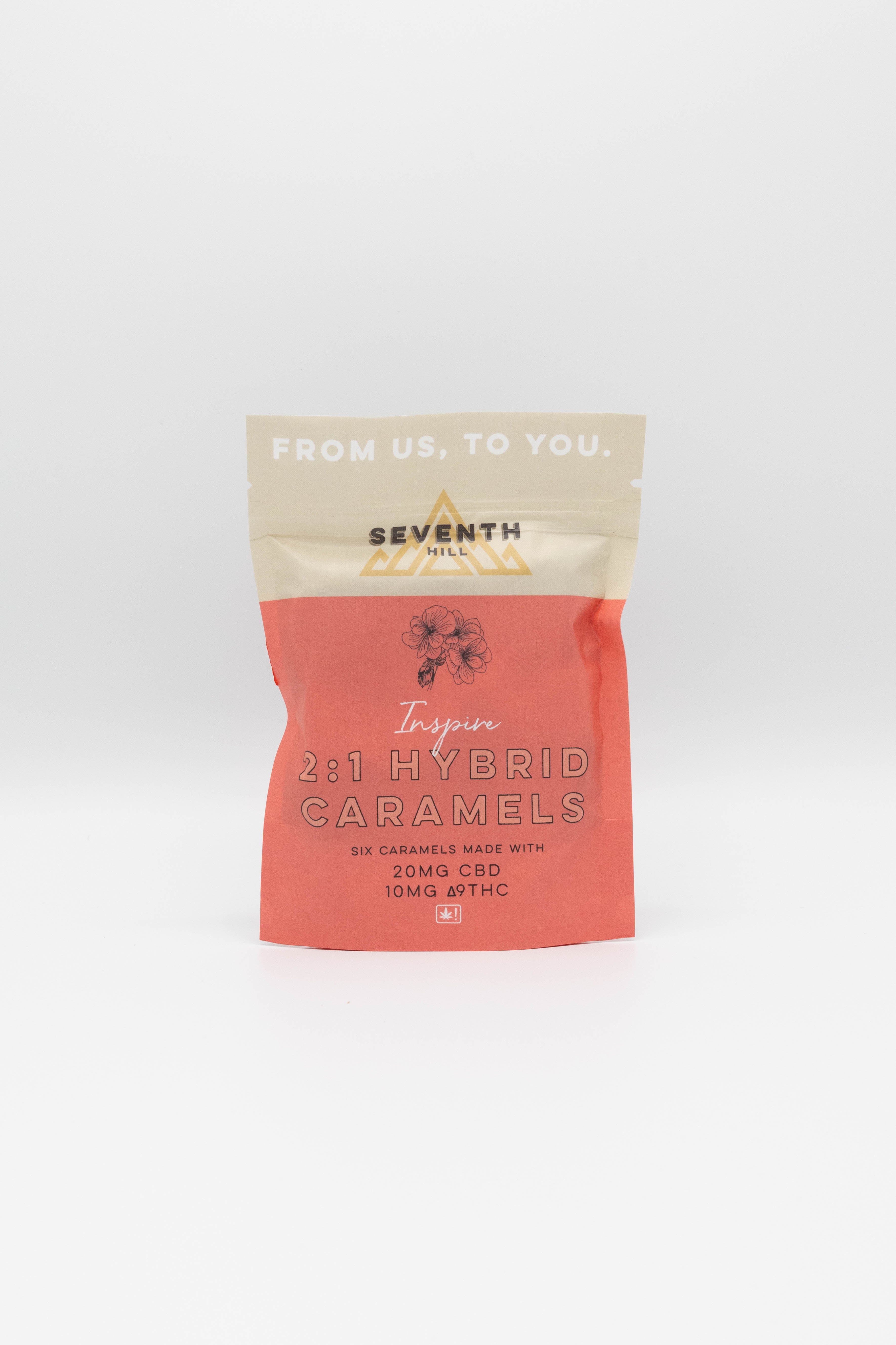 A stand-up pouch of Seventh Hill CBD caramel on a clean white background. The packaging features a coral pink lower half and a cream-colored top half with the text 'FROM US, TO YOU.