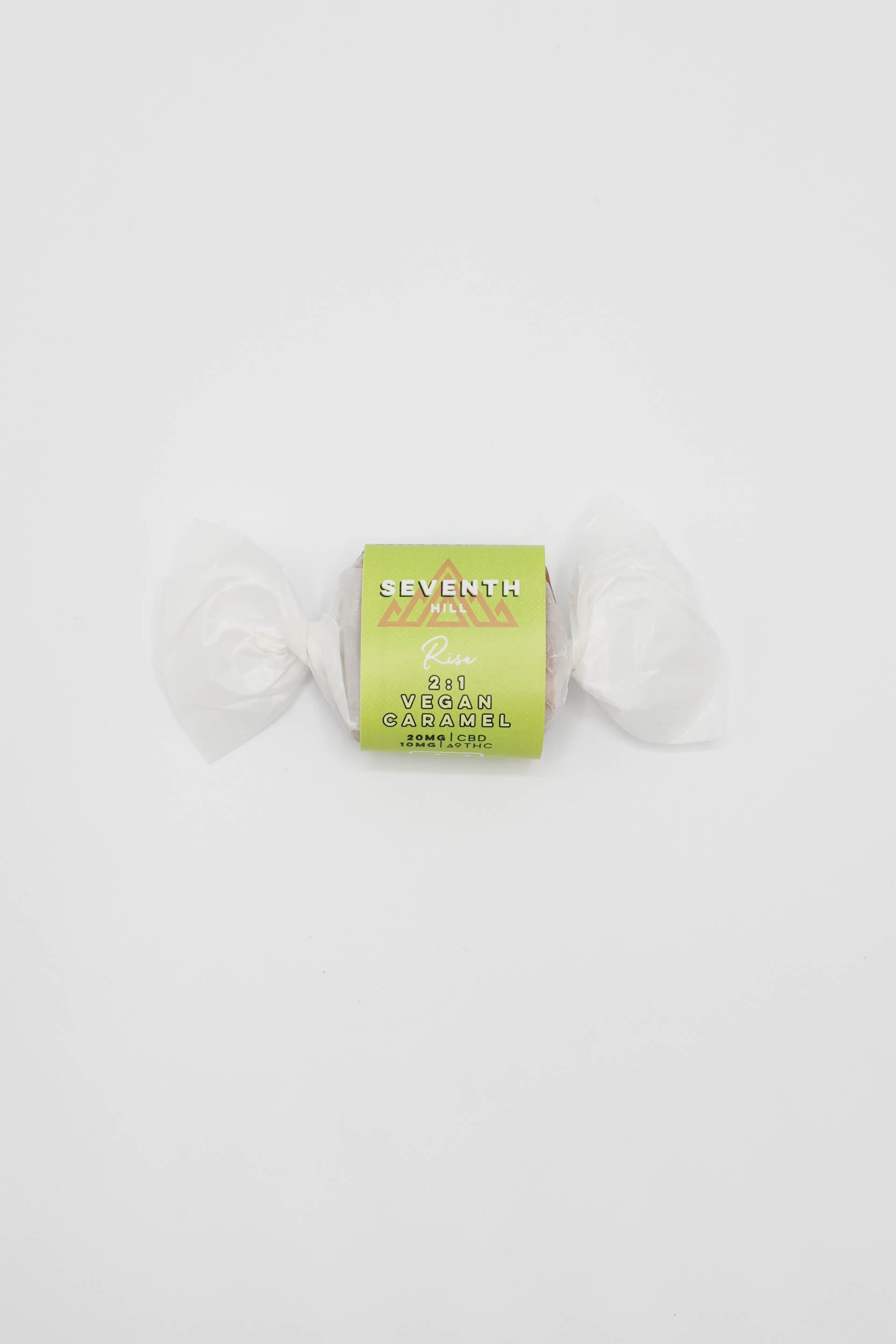 A wrapped piece of Seventh Hill 2:1 Vegan Caramel on a plain white background.