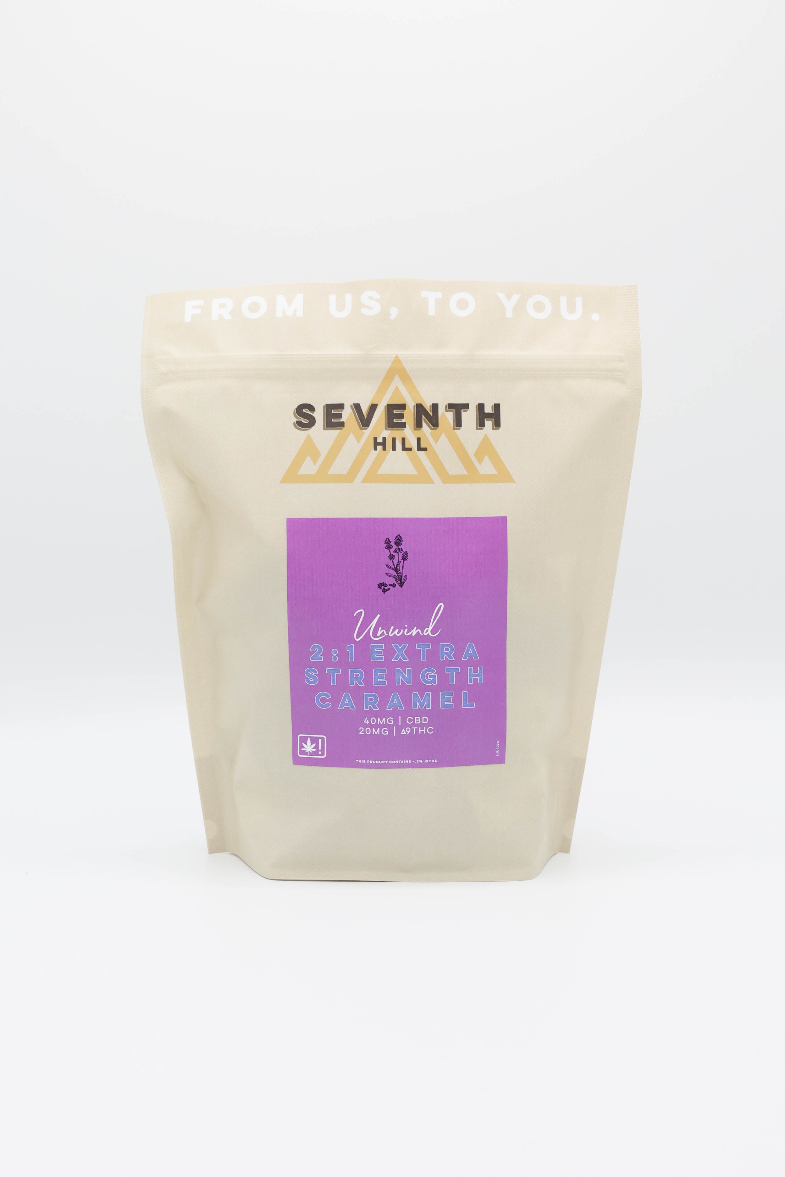 A beige stand-up pouch of Seventh Hill 2:1 Unwind Extra Strength Caramels with a purple label, photographed on a clean white background.