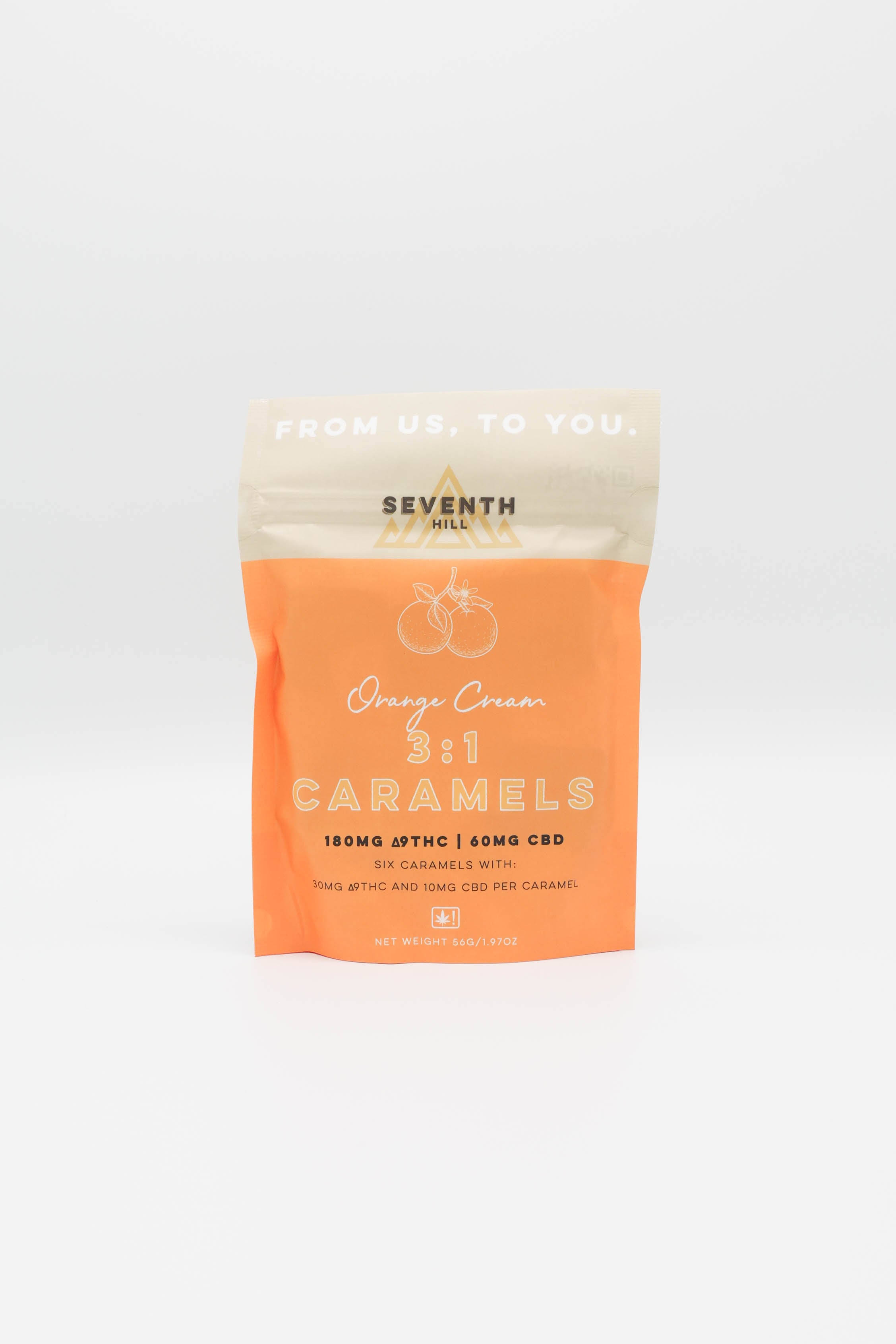 A stand-up pouch of Seventh Hill Orange Cream 3:1 Caramels, featuring a bright orange lower half and a cream-colored top seal, set against a white background.