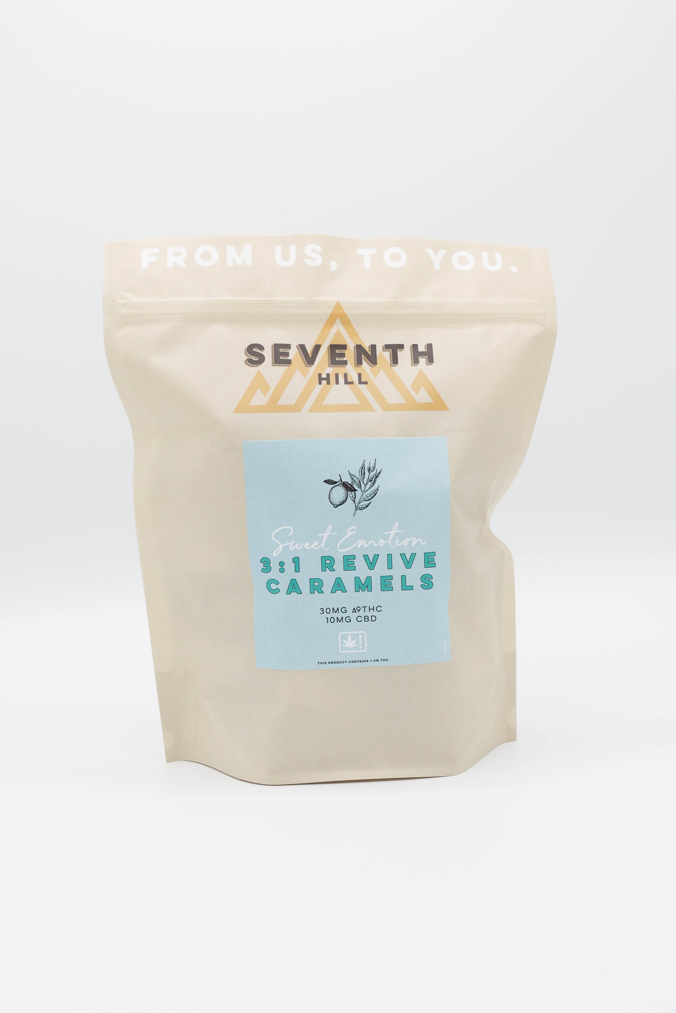 A stand-up pouch of Seventh Hill 3:1 Revive Caramels on a clean white background. The pouch is a light beige color with a central light blue label featuring teal text and a gold geometric logo.