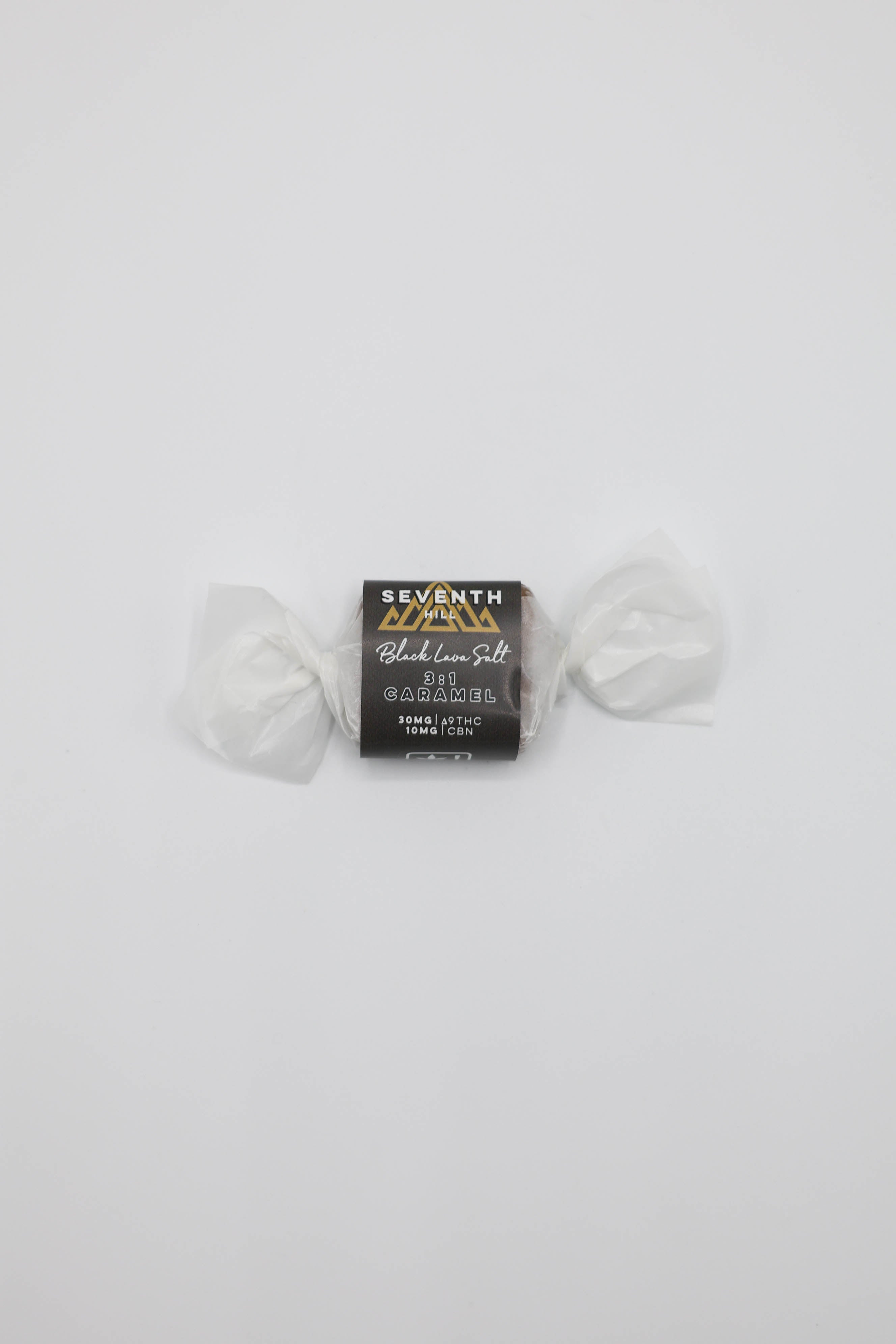 A small wrapped candy product from Seventh Hill, labeled '3:1 Black Lava Salt', centered on a plain white background.