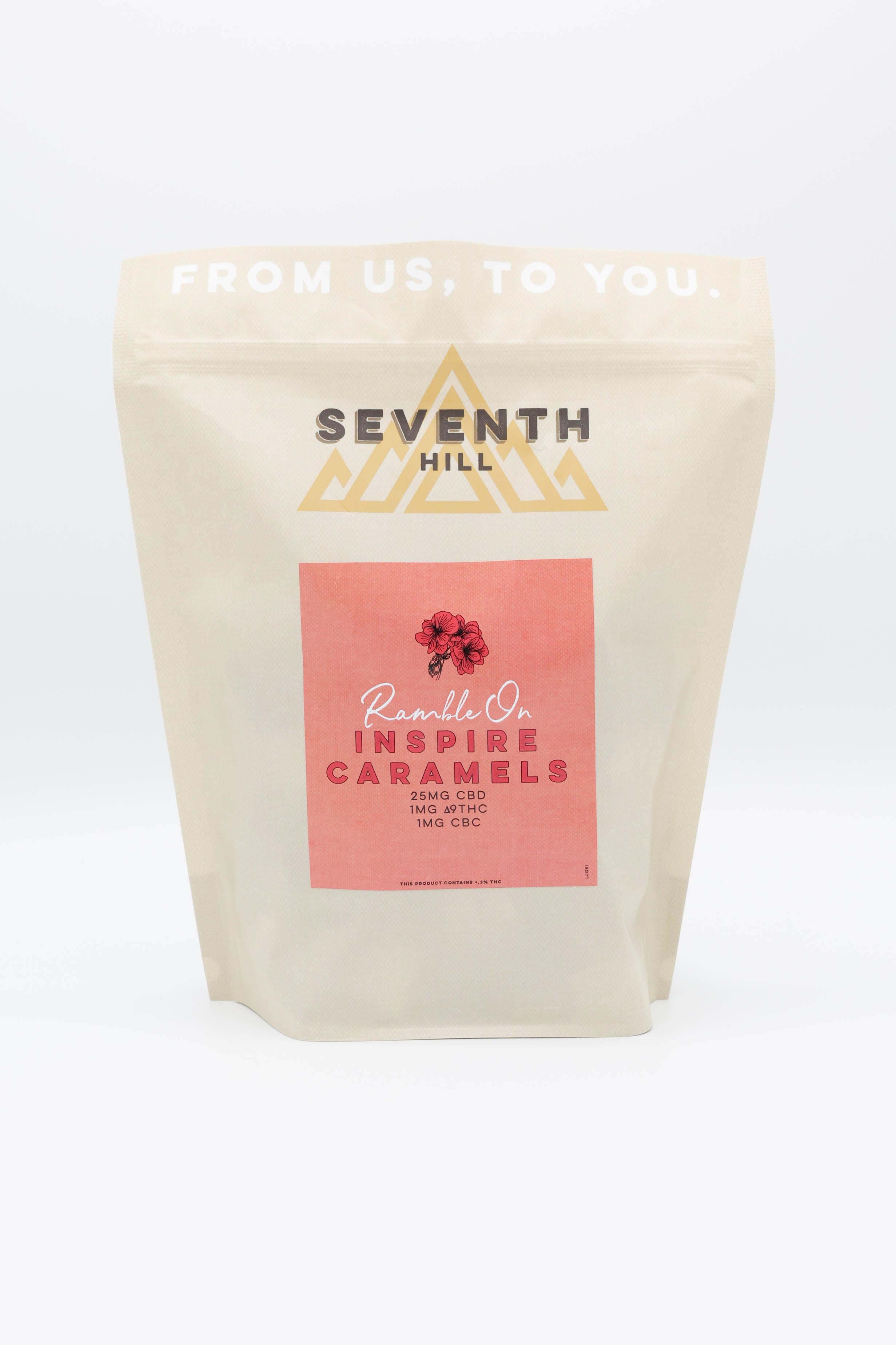 A stand-up pouch of Seventh Hill Inspire CBD Caramels on a clean white background. The pouch is a warm cream color with a prominent pink label in the center featuring a small red geranium illustration and the words 'CBD Inspire Caramels'.